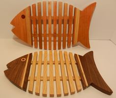 two wooden fish sculptures sitting next to each other