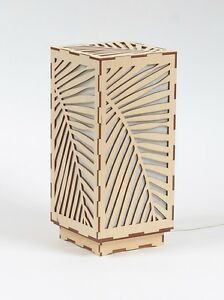 a wooden box with laser cut designs on the front and sides, sitting on a white surface