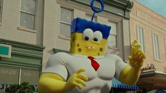 a large cartoon character is standing in front of a building with a red tie and white shirt