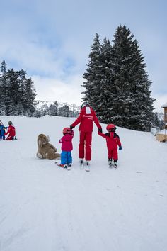 a group of people standing on top of a snow covered slope