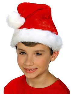 a young boy wearing a santa claus hat