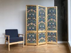 a room divider sitting on top of a hard wood floor next to a chair