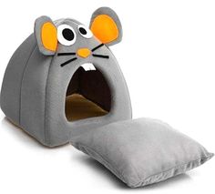 a gray cat bed with an orange nose and ears on it's head, sitting in front of a white background