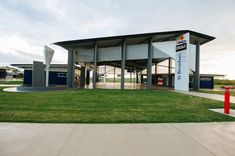 an empty building with grass in front of it