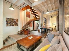 a living room filled with furniture and a spiral staircase