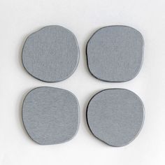 four pieces of felt sitting on top of each other in front of a white background