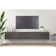 a large flat screen tv mounted to the side of a wall in a living room