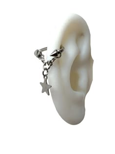 an ear with a chain attached to it and a star charm hanging from the side