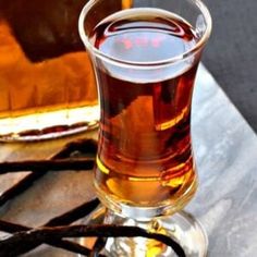 a glass filled with liquid sitting on top of a table