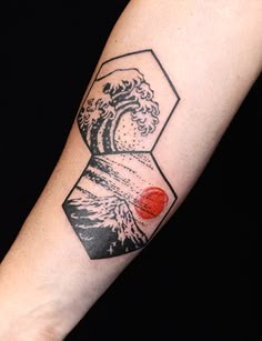 a man with a tattoo on his arm has a wave coming out of the ocean