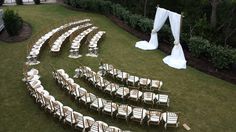 an aerial view of a wedding set up with chairs and draping on the lawn