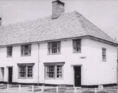 an old black and white photo of a house