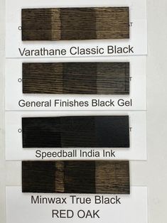 four different shades of black and white paint on the side of a sign that says,