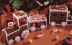 three baskets filled with candy and candies on top of a table next to a christmas tree