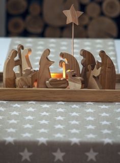 a wooden nativity scene with three wise men and a star on the table top