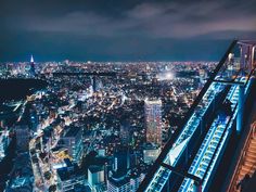 an aerial view of the city at night from top of a skyscraper in tokyo, japan