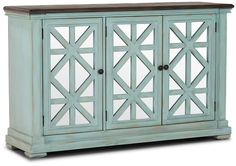 an old blue cabinet with mirrored doors