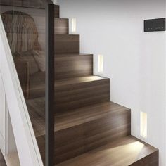 the stairs are made of wood and have lights on them