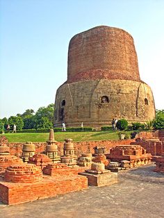 an old brick structure in the middle of a park