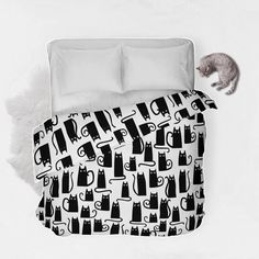 a black and white bed with cats on it