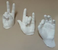 three hand gestures made out of white plastic