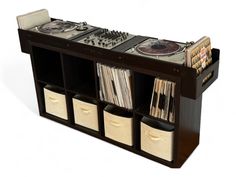 an entertainment center with record players and tape recorders on the shelves next to each other