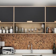 the kitchen counter is covered with wine glasses and cups