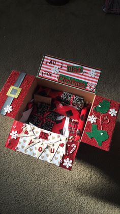 an open christmas gift box on the floor