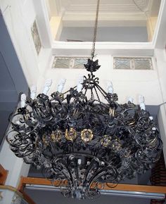 an ornate chandelier hangs from the ceiling