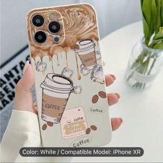 a woman holding up her phone case with coffee on it