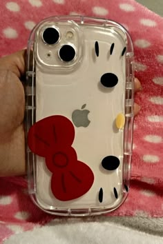 someone is holding an iphone case with hearts on it