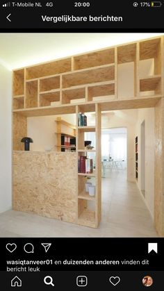 a room that has some bookshelves and shelves on the wall in front of it