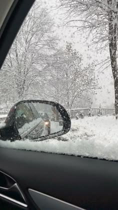 a car's side view mirror is covered in snow