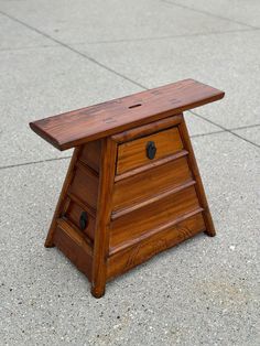 a small wooden table sitting on the ground