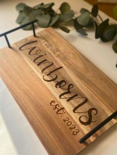 a wooden sign that says welcome to our guests and is hanging on a metal holder