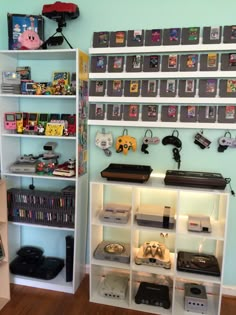 there are many video games on shelves in this room