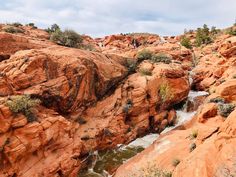 the water is running down the red rocks