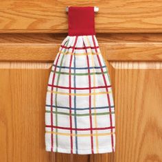 a kitchen towel hanging on the handle of a cabinet