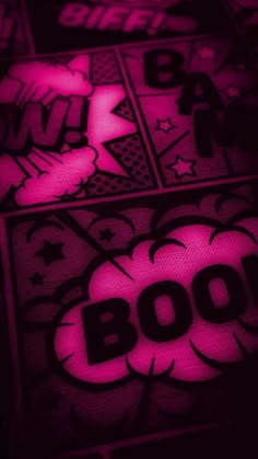 the word boo is lit up in pink and black with white stars on it's side