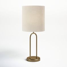 a lamp on a white background with a light shade in the middle and an oval base at the bottom