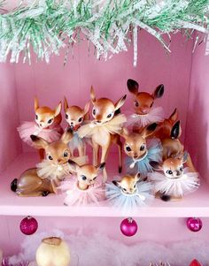 a pink shelf filled with little deer figurines