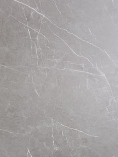 a white marble textured wall and floor with grey veining on it's edges