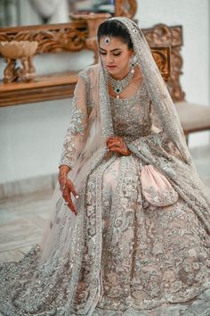 a woman in a wedding dress sitting down