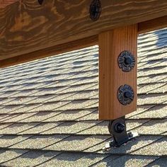 a wooden bench with metal knobs on it