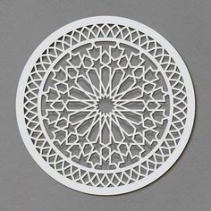 a white circular cutout with an intricate design