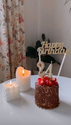 a happy birthday cake with candles on a table