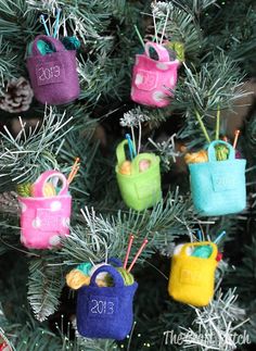 small purses are hanging from the tree for christmas decorations, ornament holders