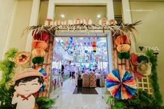 an entrance to a store decorated with paper decorations