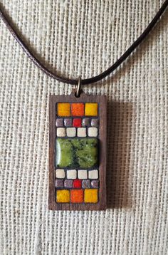 Beautiful tiny tiles surround this mosaic pendant with a beautiful green stone.  Set in a wood hand made base and hung on tan 17-18" cord. ** All designs exclusive to Nikki Sullivan Mosaics** Mosaic Tiles Diy, Tiny Tiles, Tiles Diy, Micro Mosaic Jewelry, Mosaic Jewelry, Micro Mosaic, Wood Pendant, Green Stone, Mosaic Tiles