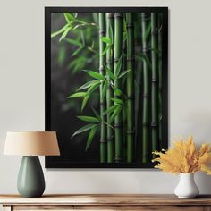 a table with a vase and lamp on it next to a wall mounted photograph of bamboo